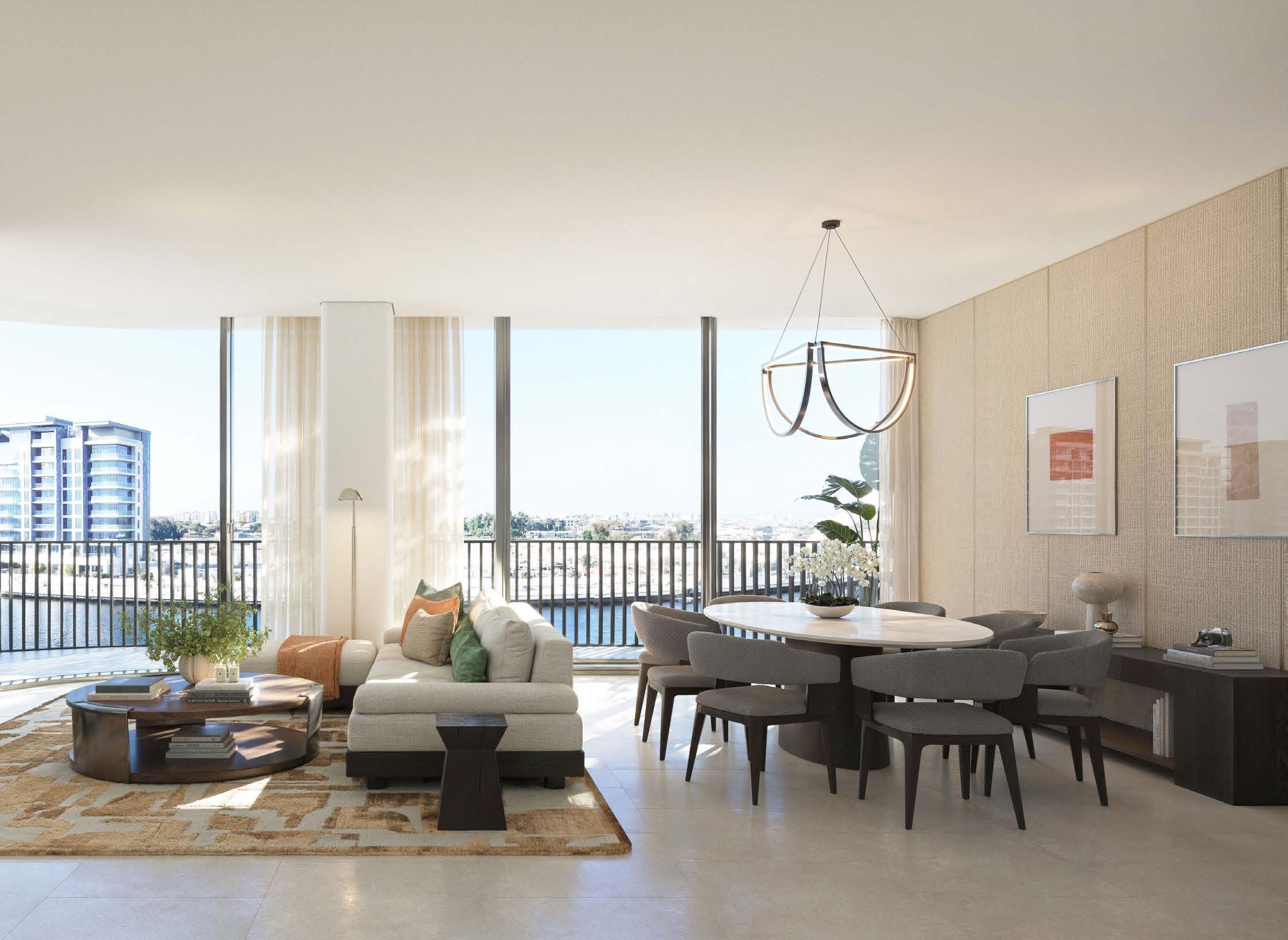 Open-plan living and dining room in a four bedroom residence, looking over the Dubai Water Canal