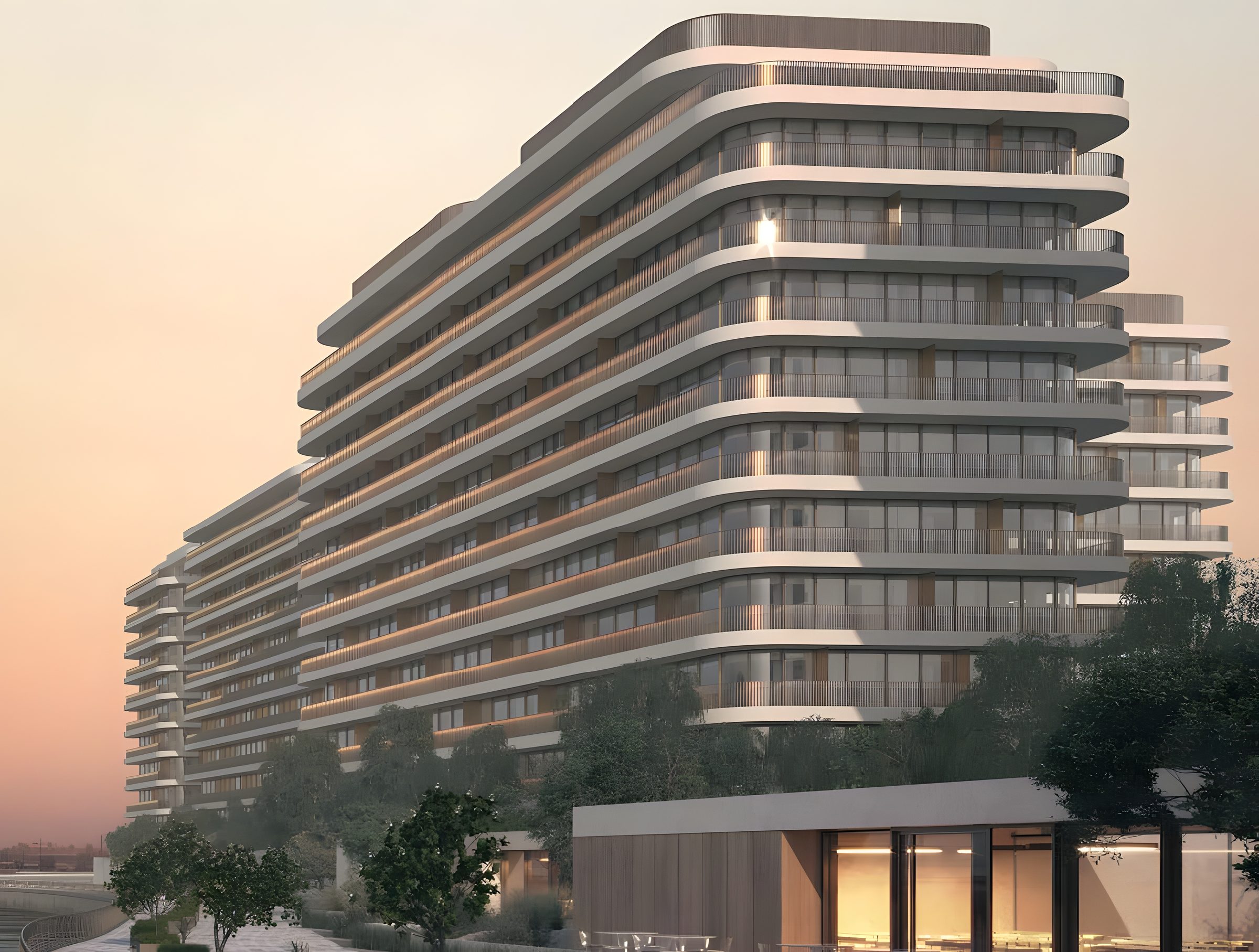 The curved, stacked balconies of Eden House The Park against a dusk sky