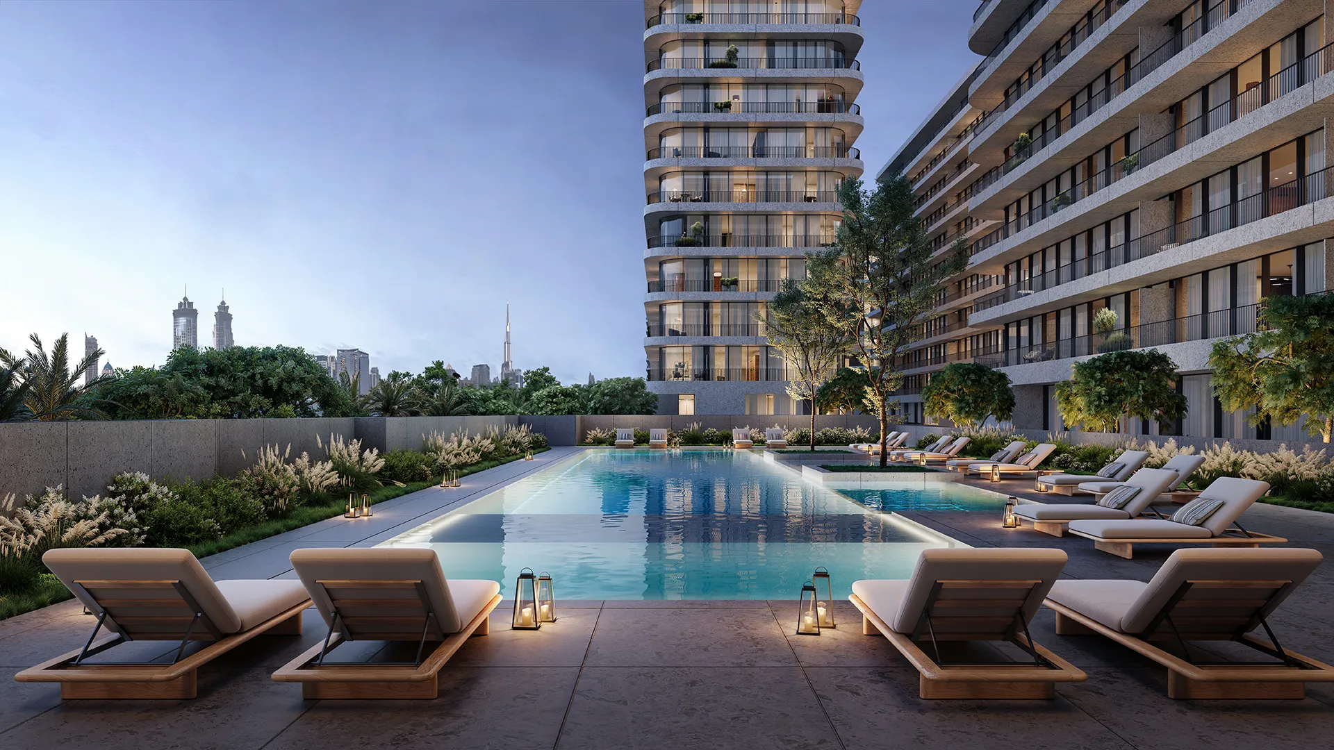 A lap pool with sun loungers between two of the buildings